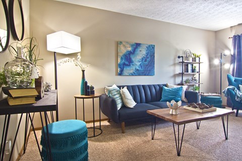 a living room with a blue couch and a coffee table