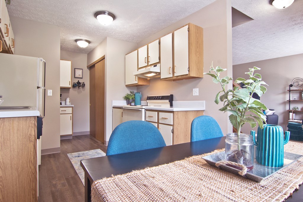 the view of a dining room and kitchen in an apartment
