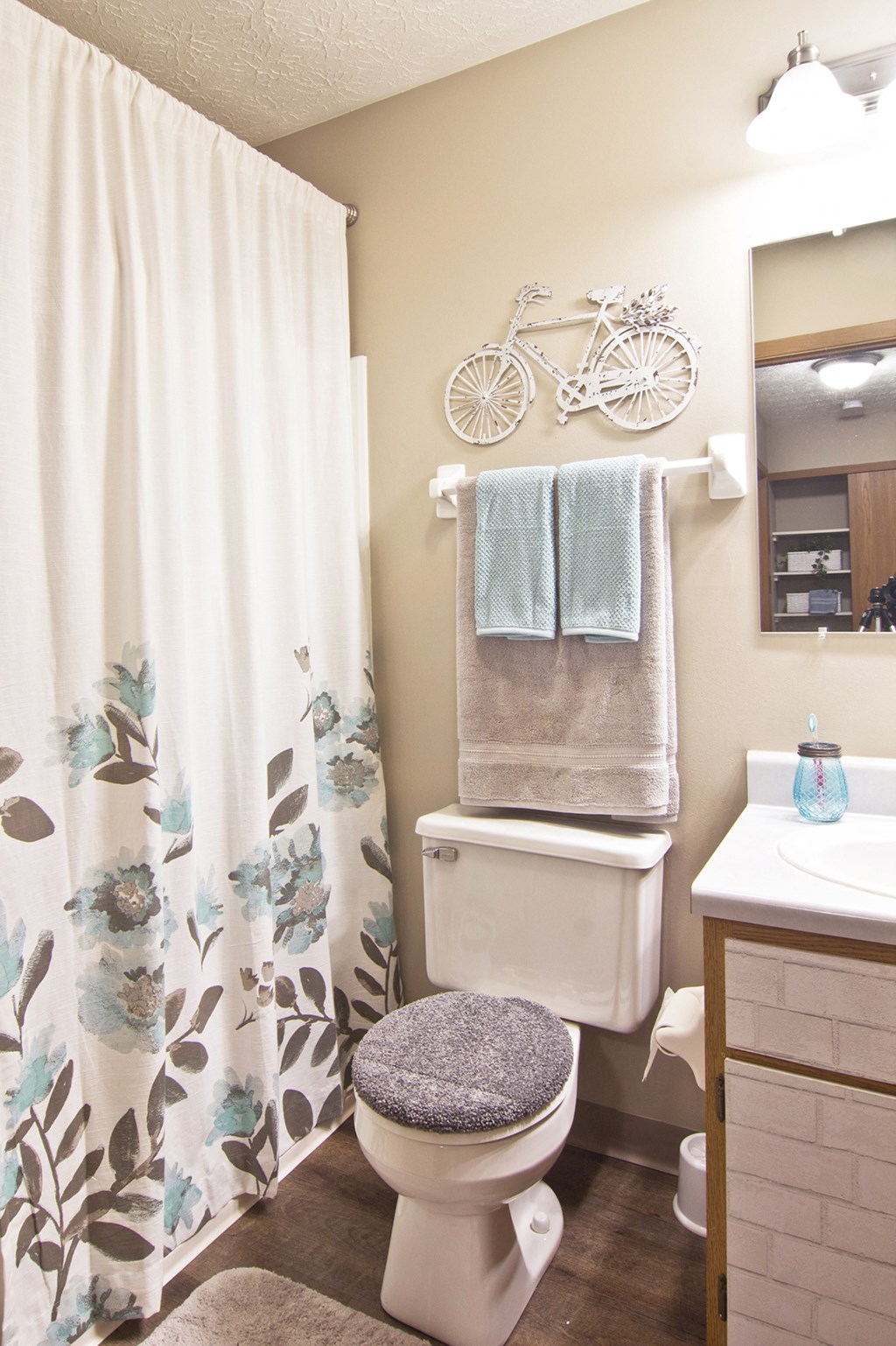 a bathroom with a shower curtain and a toilet and a sink