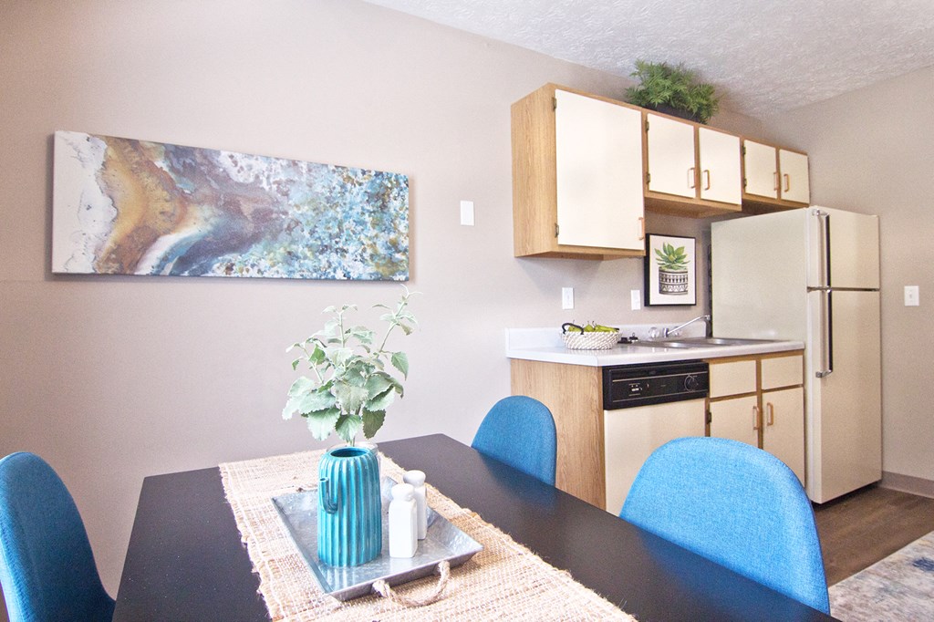 an open kitchen and dining room with a table and chairs