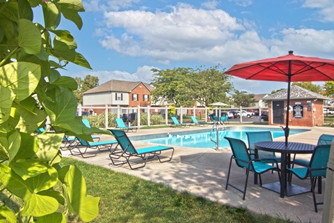 our apartments have a pool and a patio with chairs and tables