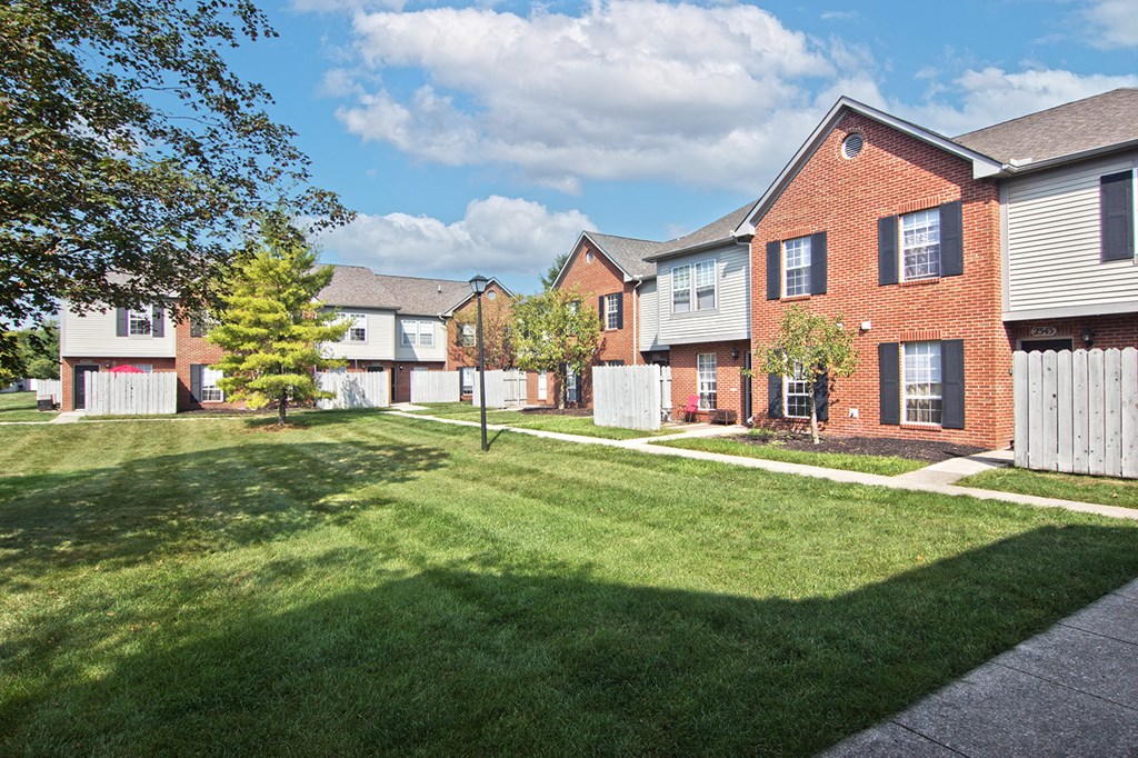 a yard in front of a row of houses