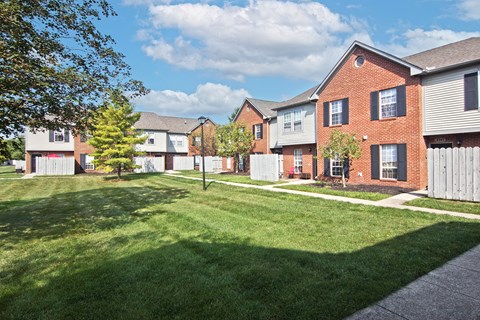 a yard in front of a row of houses