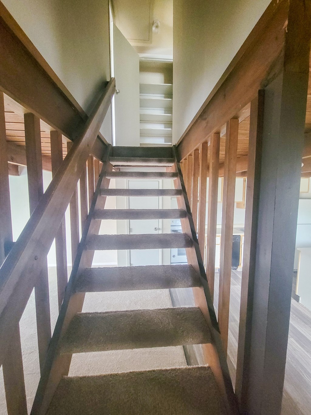 looking down the stairs from the second floor