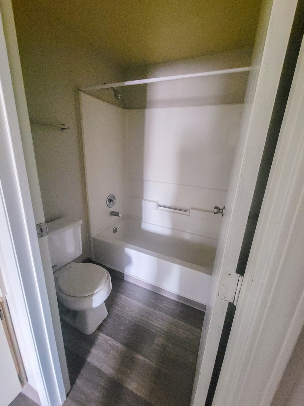 a small bathroom with a toilet and a bathtub