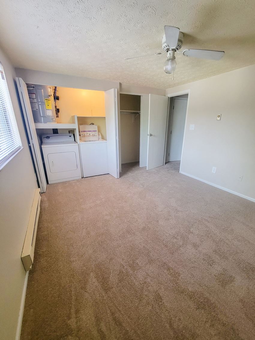 an empty living room with a ceiling fan - Photo Gallery