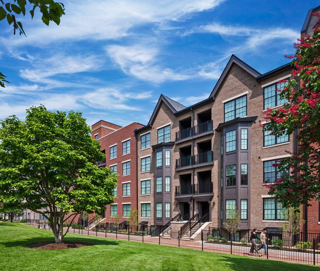 a large apartment building with a tree in front of it