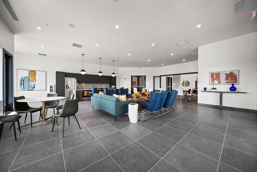 A modern living room with a grey floor and white walls.