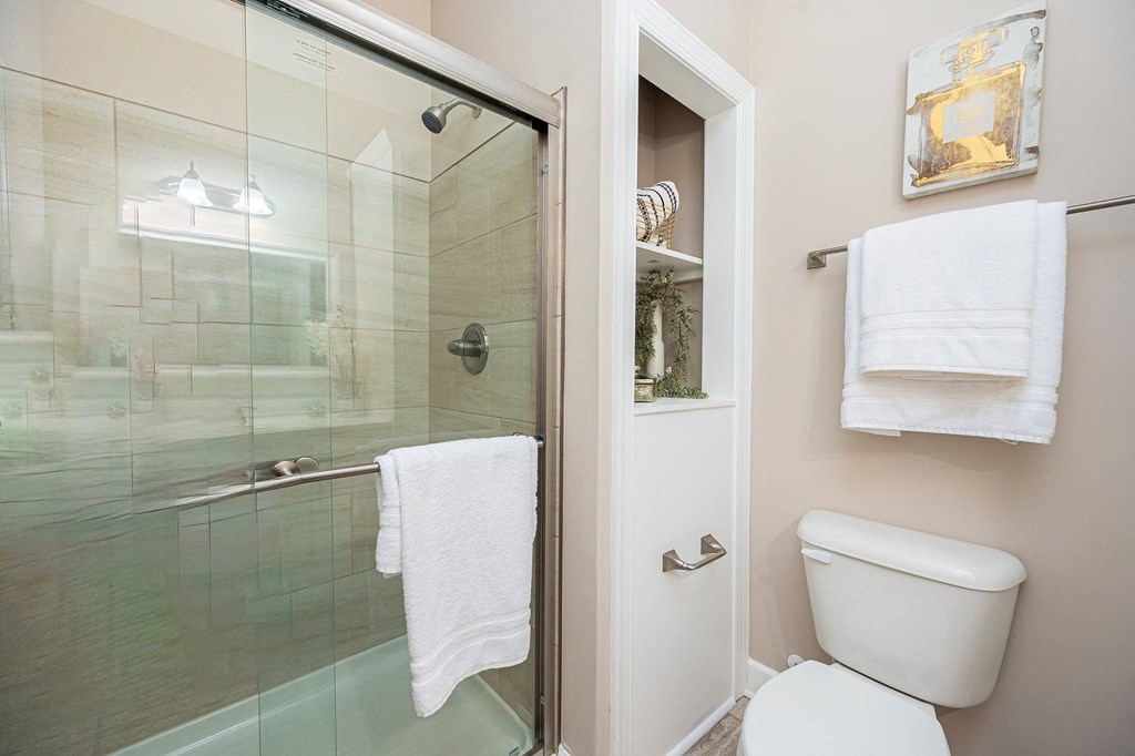 a bathroom with a toilet and a glass shower