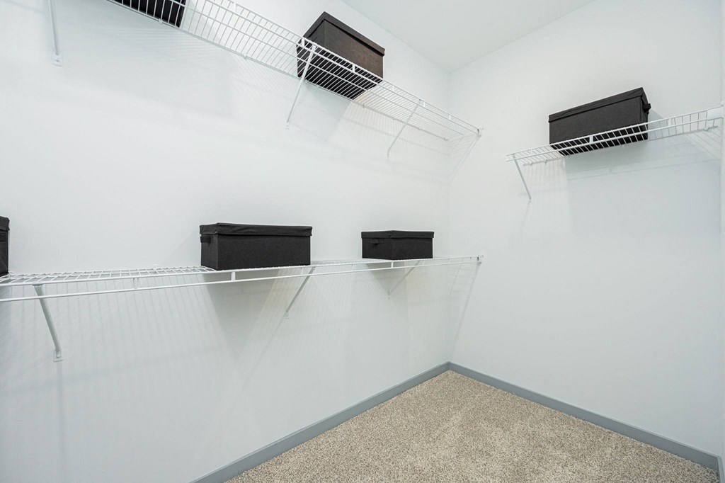 a display case in a white room with three black boxes