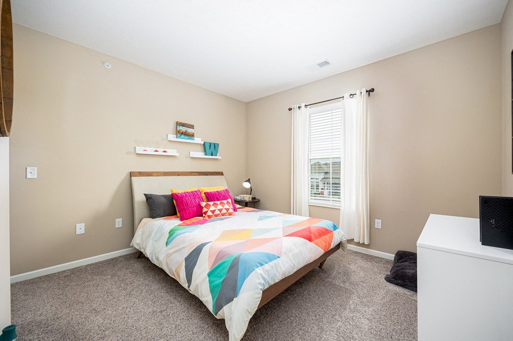 a bedroom with a bed and a window