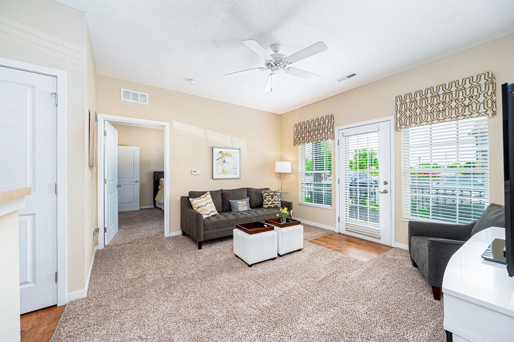 a living room with a couch and a ceiling fan