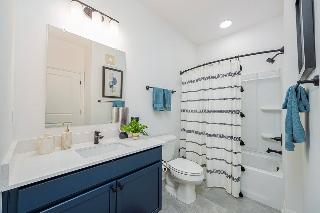 A bathroom with a white toilet, a white sink, and a white bathtub.