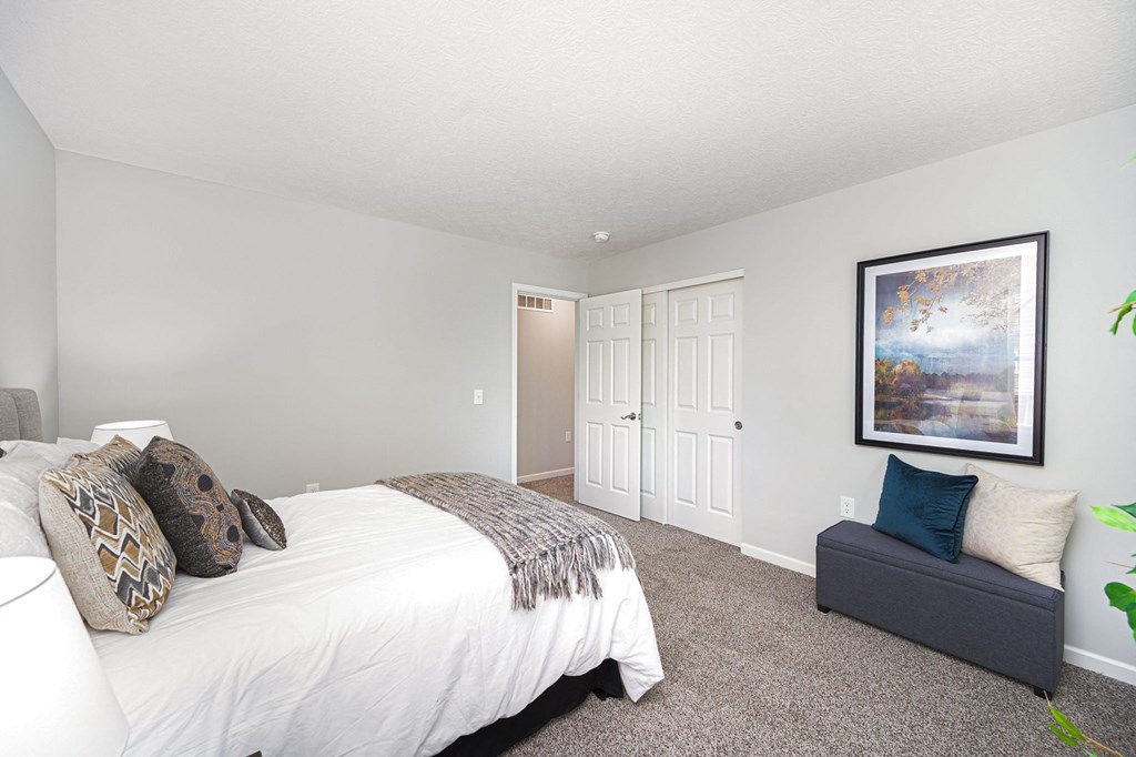 a bedroom with a bed and a couch