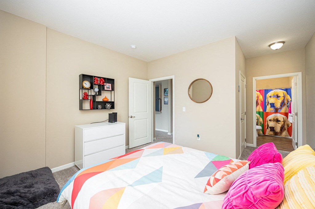 a bedroom with a bed and a door to a closet