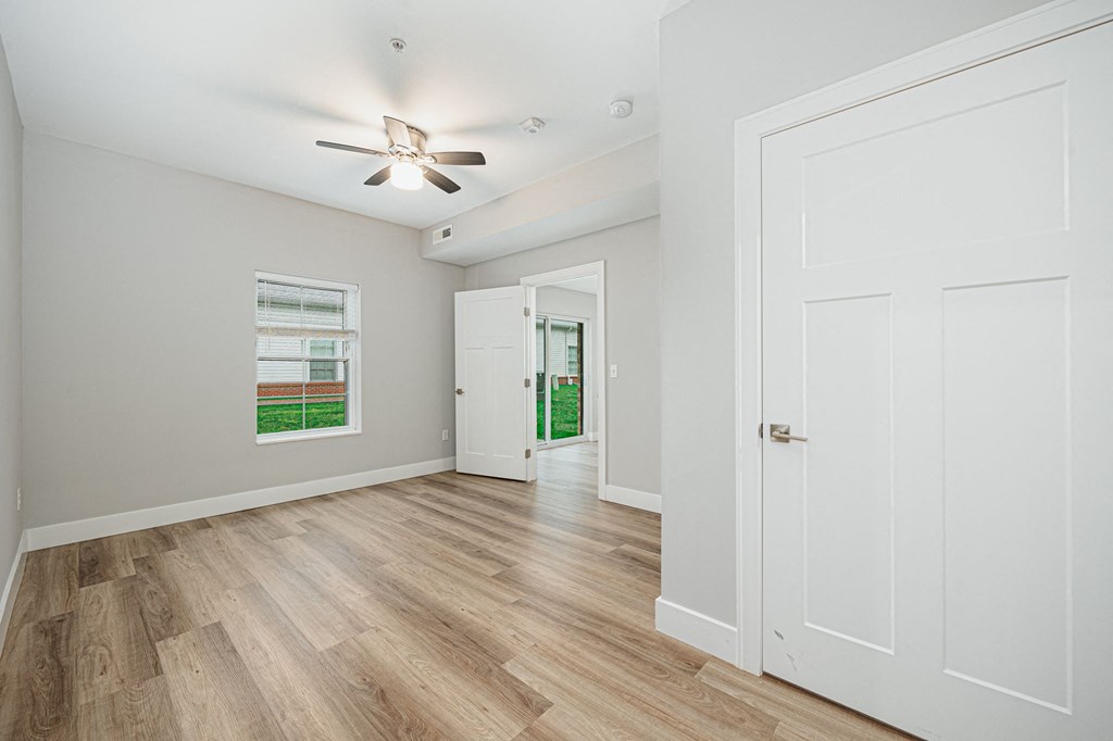the living room and dining room of a new home with white walls and wood floors