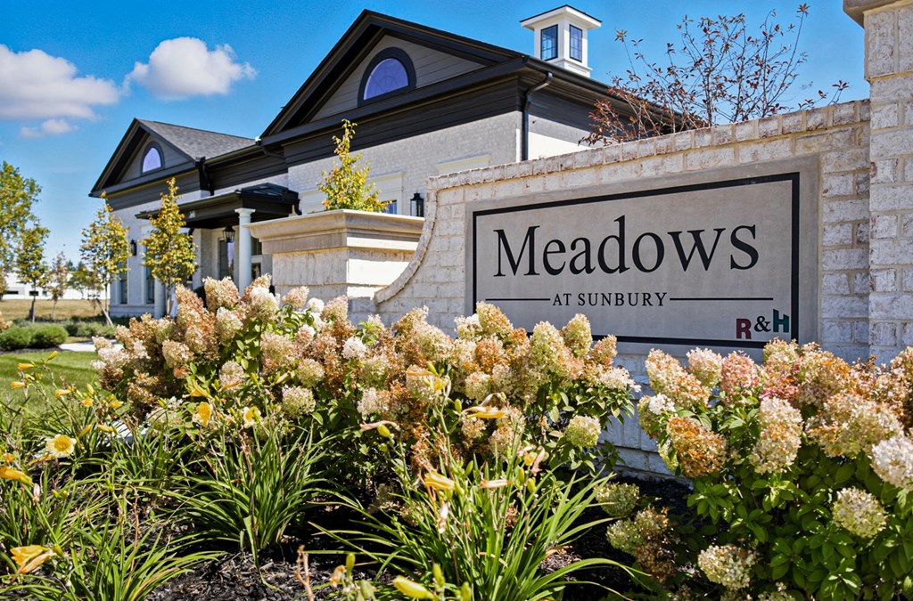 A sign that says Meadows at Sunbury in front of a building.
