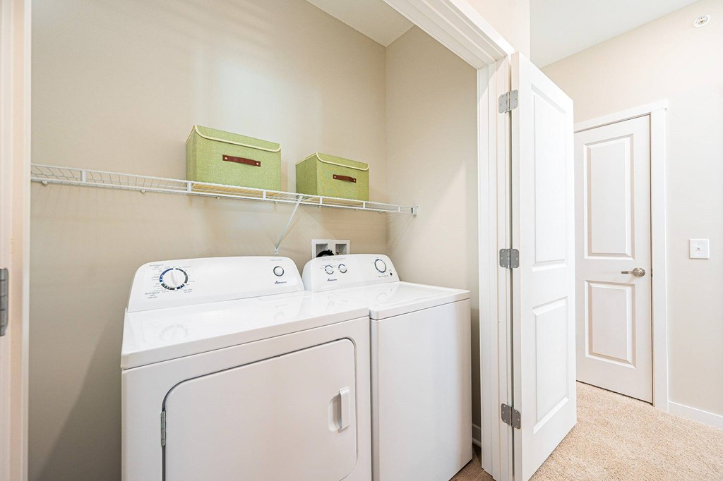 A white washer and dryer in a laundry room.