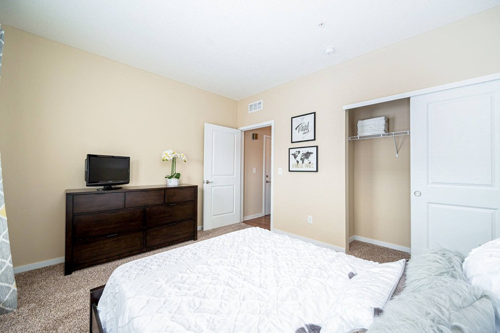 a bedroom with a large bed and a tv