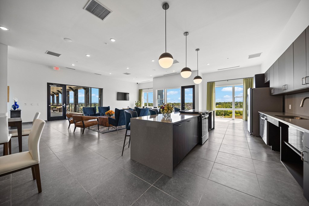 A modern kitchen with a large island and a dining area.
