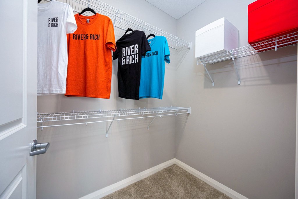 dual closets with towels and tee shirts in a clubhouse