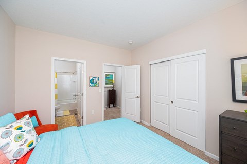 a bedroom with a bed and a closet