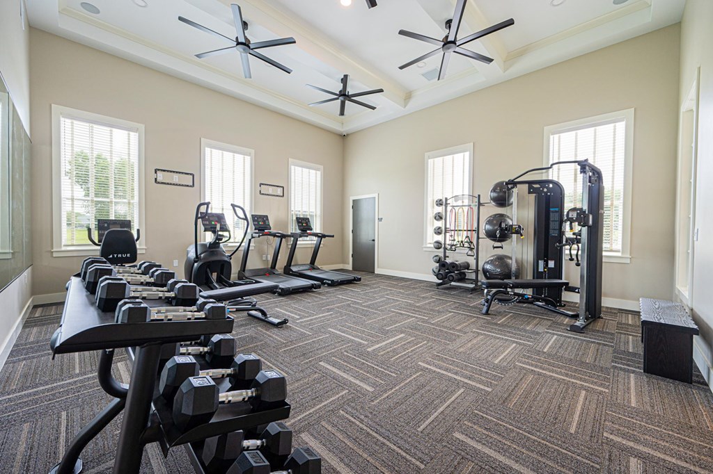 A spacious home gym with a variety of exercise equipment.