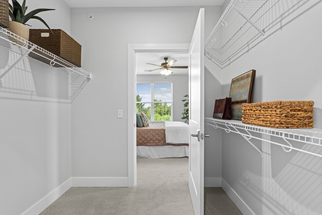 A white room with a white door leading to a balcony.