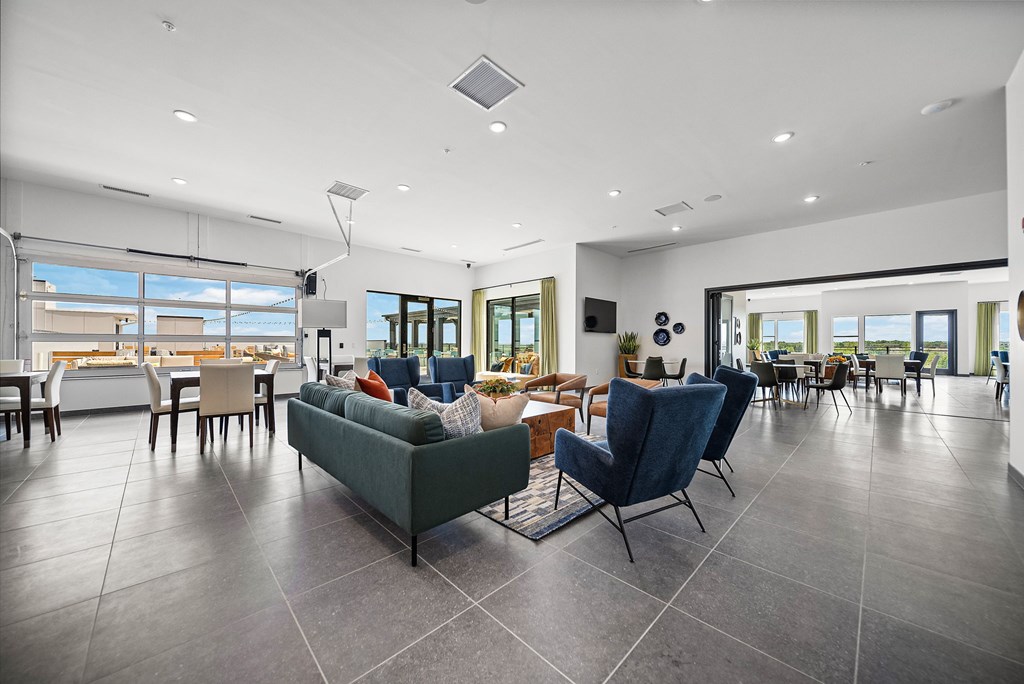 A modern living room with a grey sofa and chairs.
