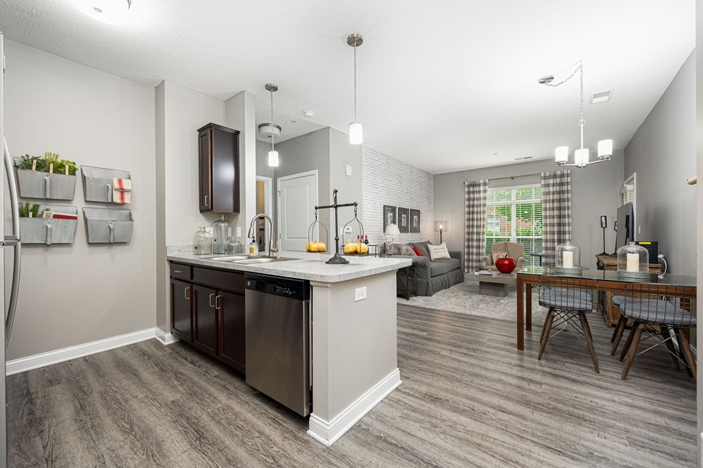 an open kitchen and living room with a table and chairs