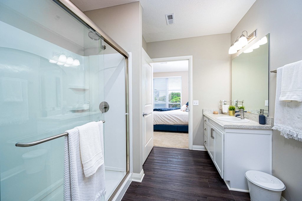 a bathroom with a shower and a sink and a toilet