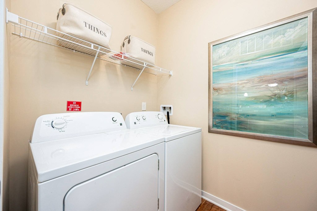 a washer and dryer in the laundry room of a rental home