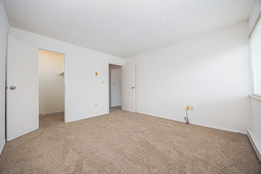 A room with carpeted floor and white walls.
