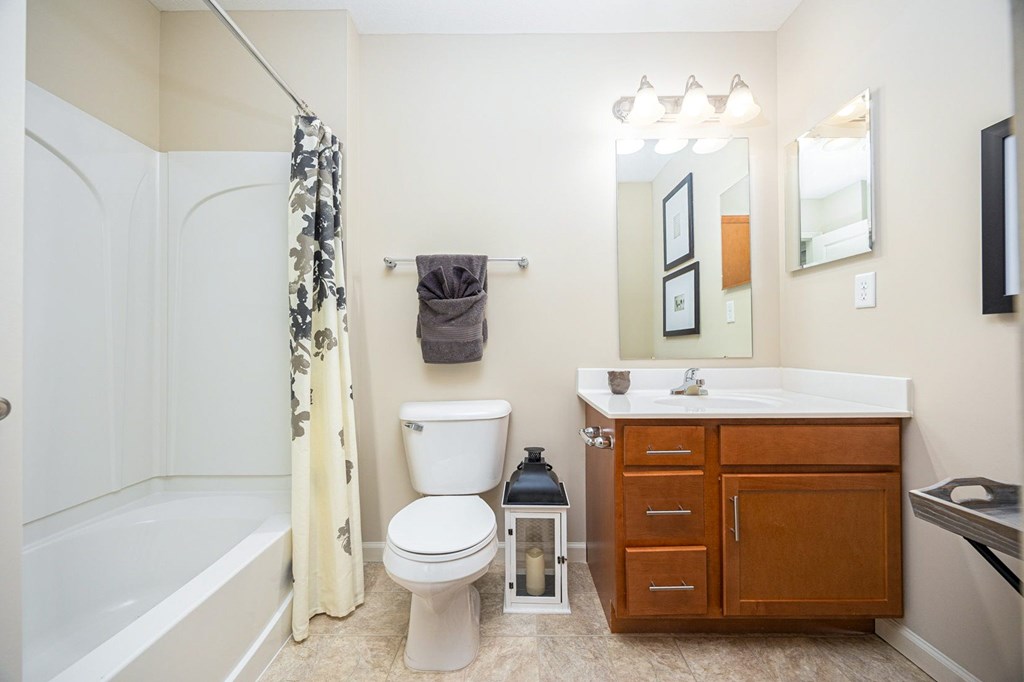 A bathroom with a white toilet, a white sink, and a white bathtub.