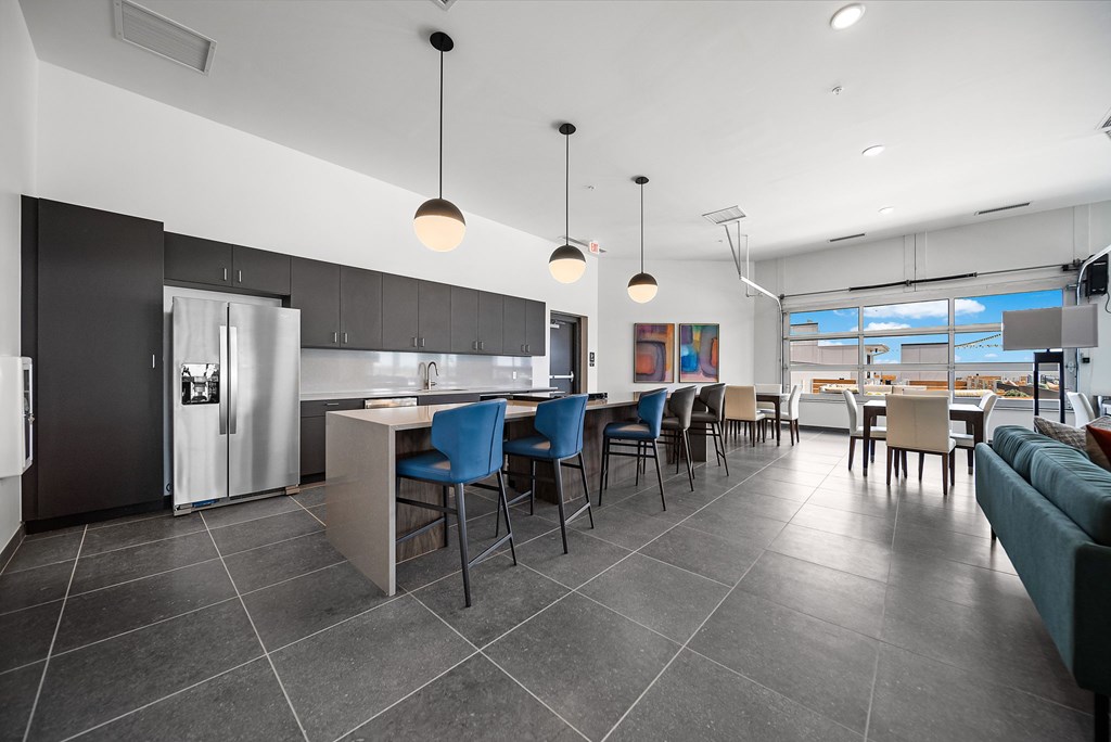 A modern kitchen with a dining area and a large window.