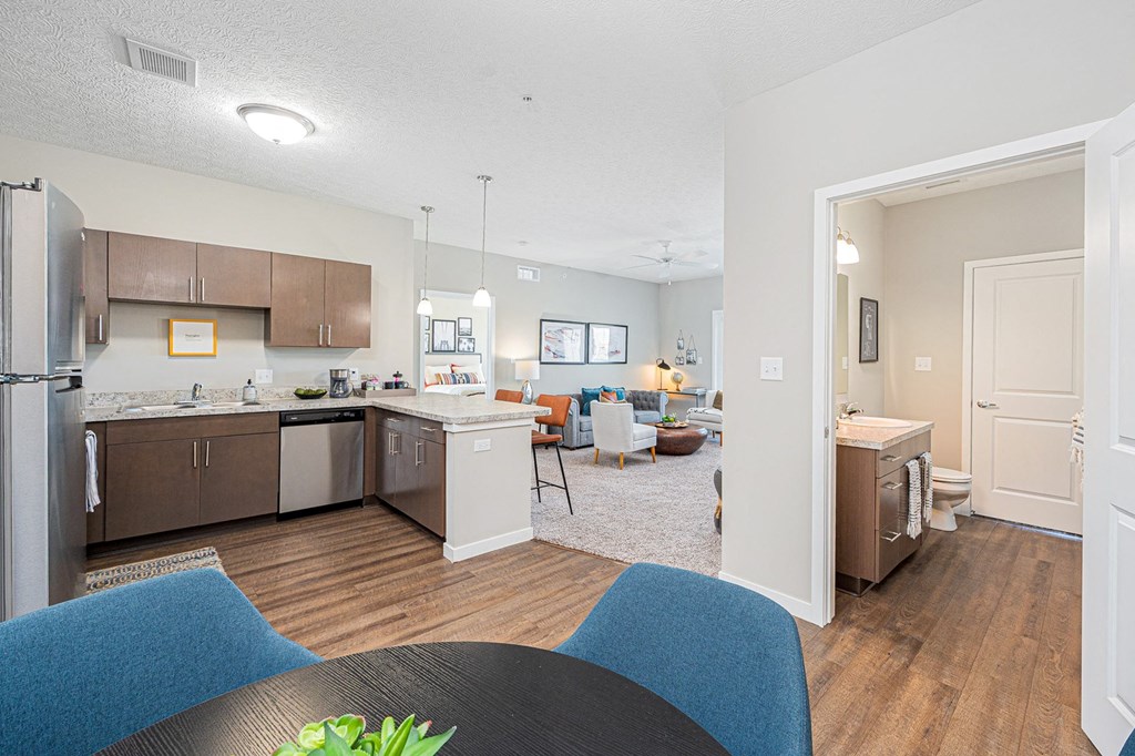 a kitchen and living room with a table and chairs