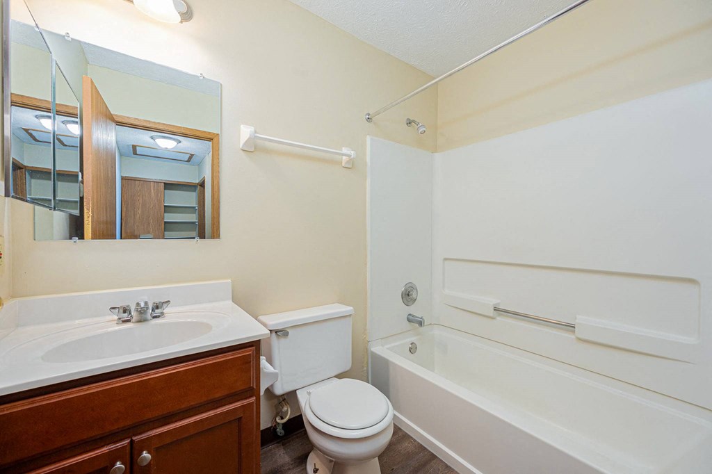a bathroom with a sink toilet and a bath tub
