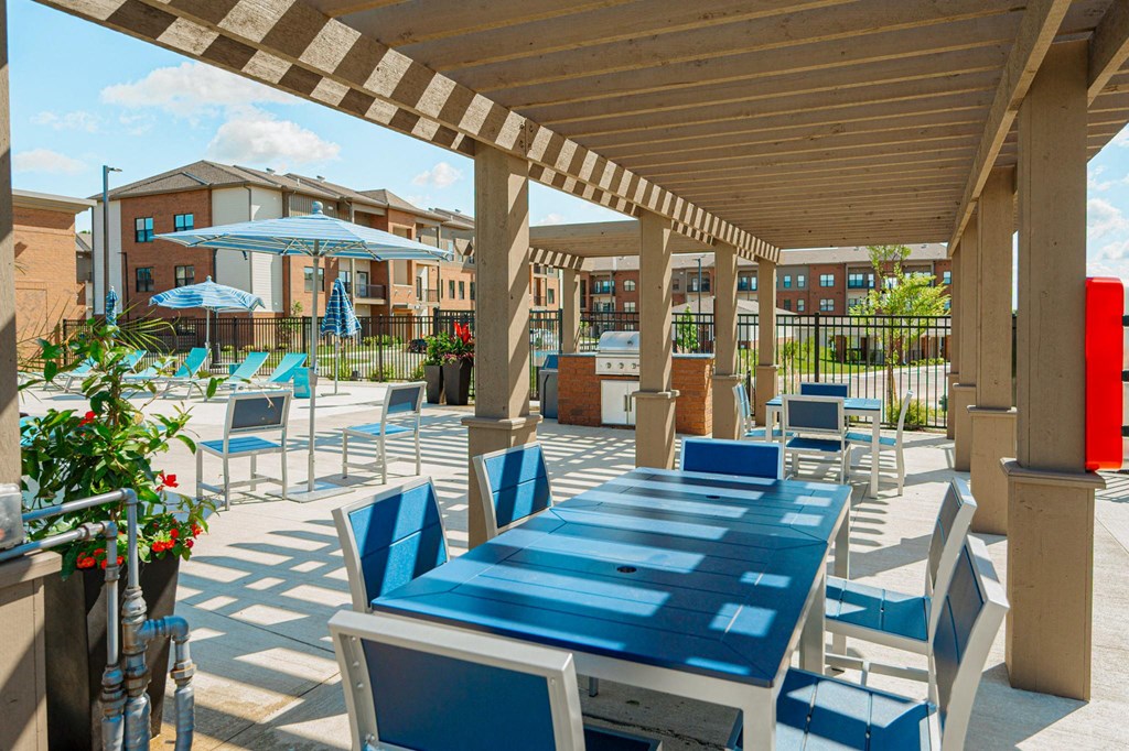 a covered patio with tables and chairs and umbrellas