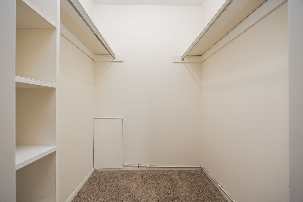 A white room with a carpeted floor and white walls.