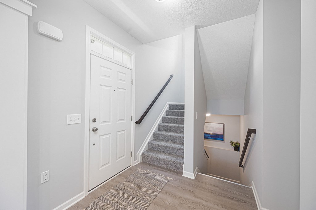 the entryway of liberty reserve with stairs and a white door