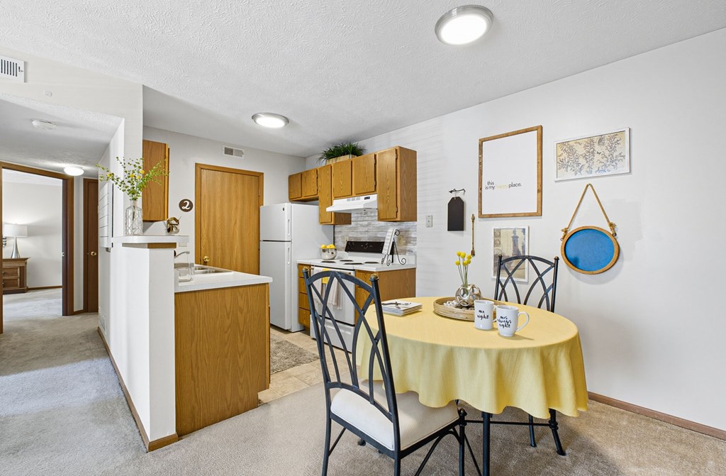 A kitchen with a table set for two.