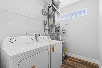 A white washing machine and dryer in a small laundry room.