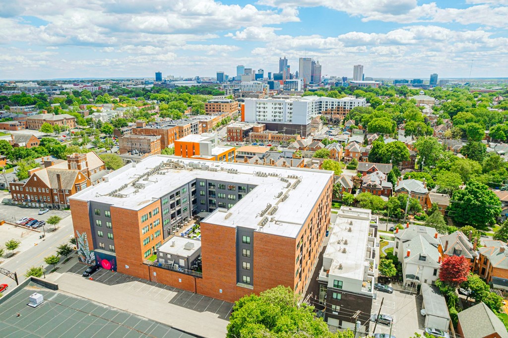 an aerial view of a building with a city in the background