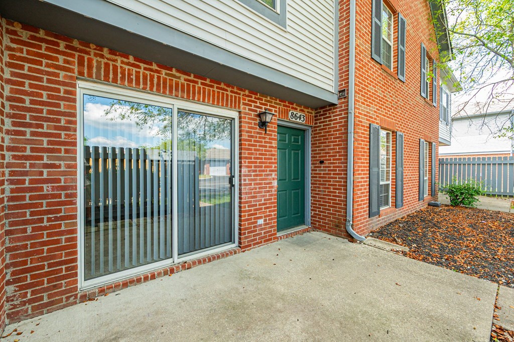 the entrance to a brick building with a green door