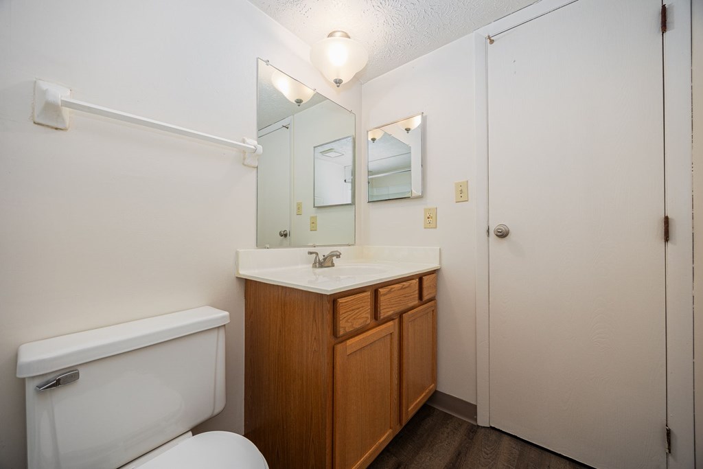 A white toilet sits next to a sink in a small bathroom.