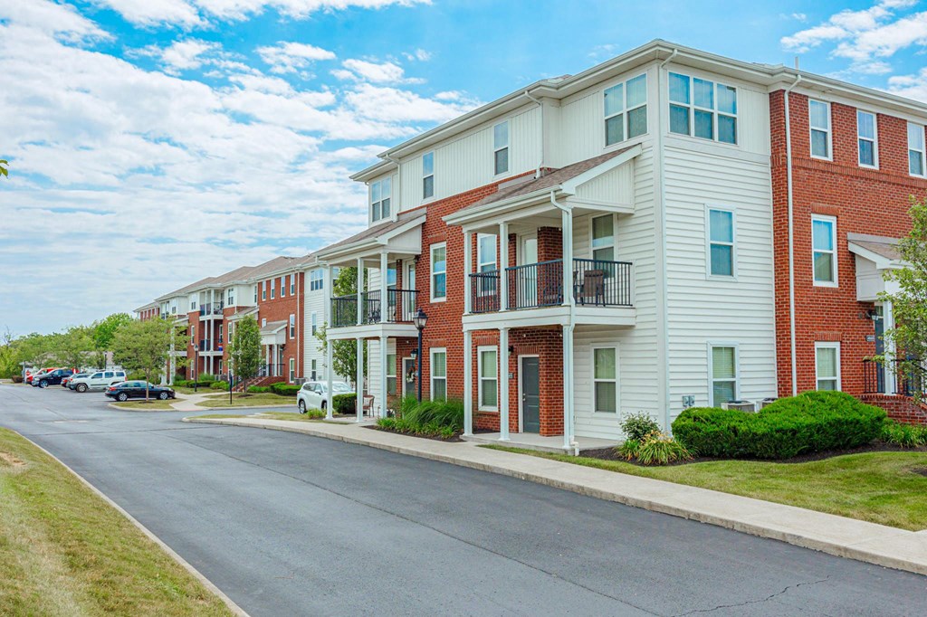an empty street in front of an apartment building