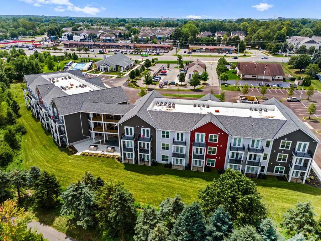 A large building complex with multiple buildings and a parking lot.