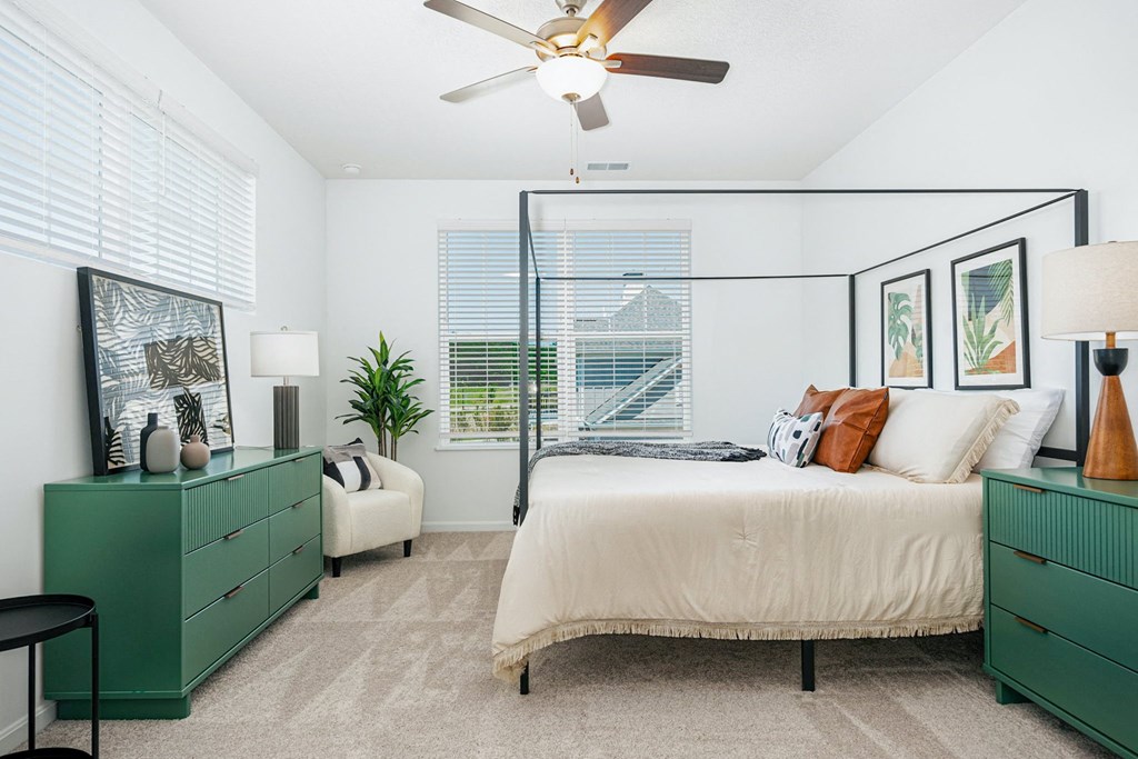 a bedroom with a bed and a ceiling fan