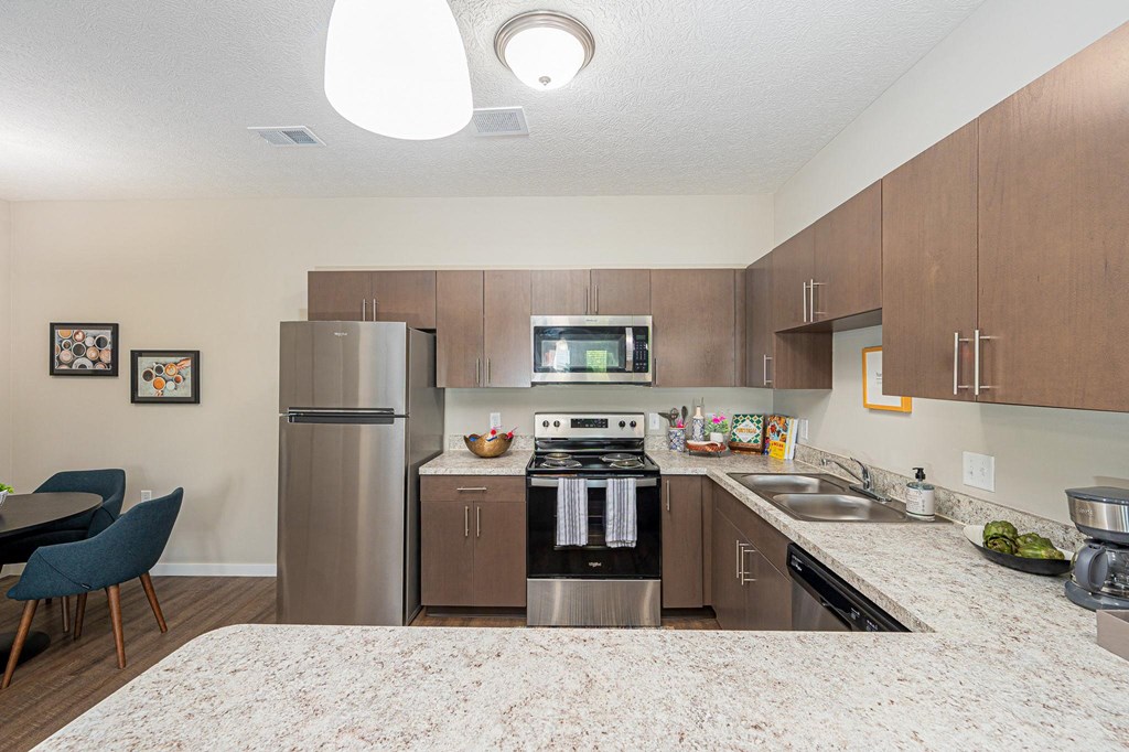 a kitchen with stainless steel appliances and granite counter tops