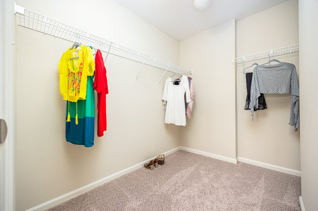 A hallway with clothes hanging on the wall.